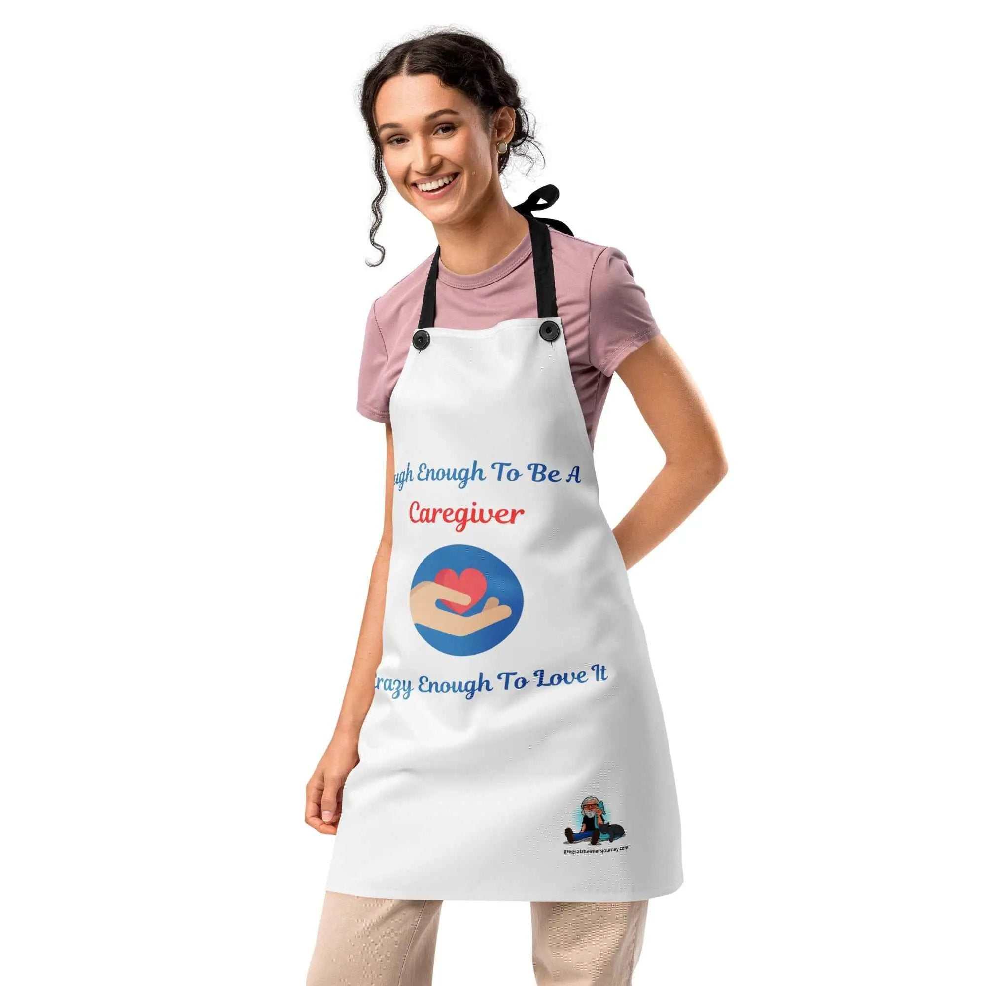 Woman wearing a white Caregiver Alzheimer's Awareness apron with heart graphic and text