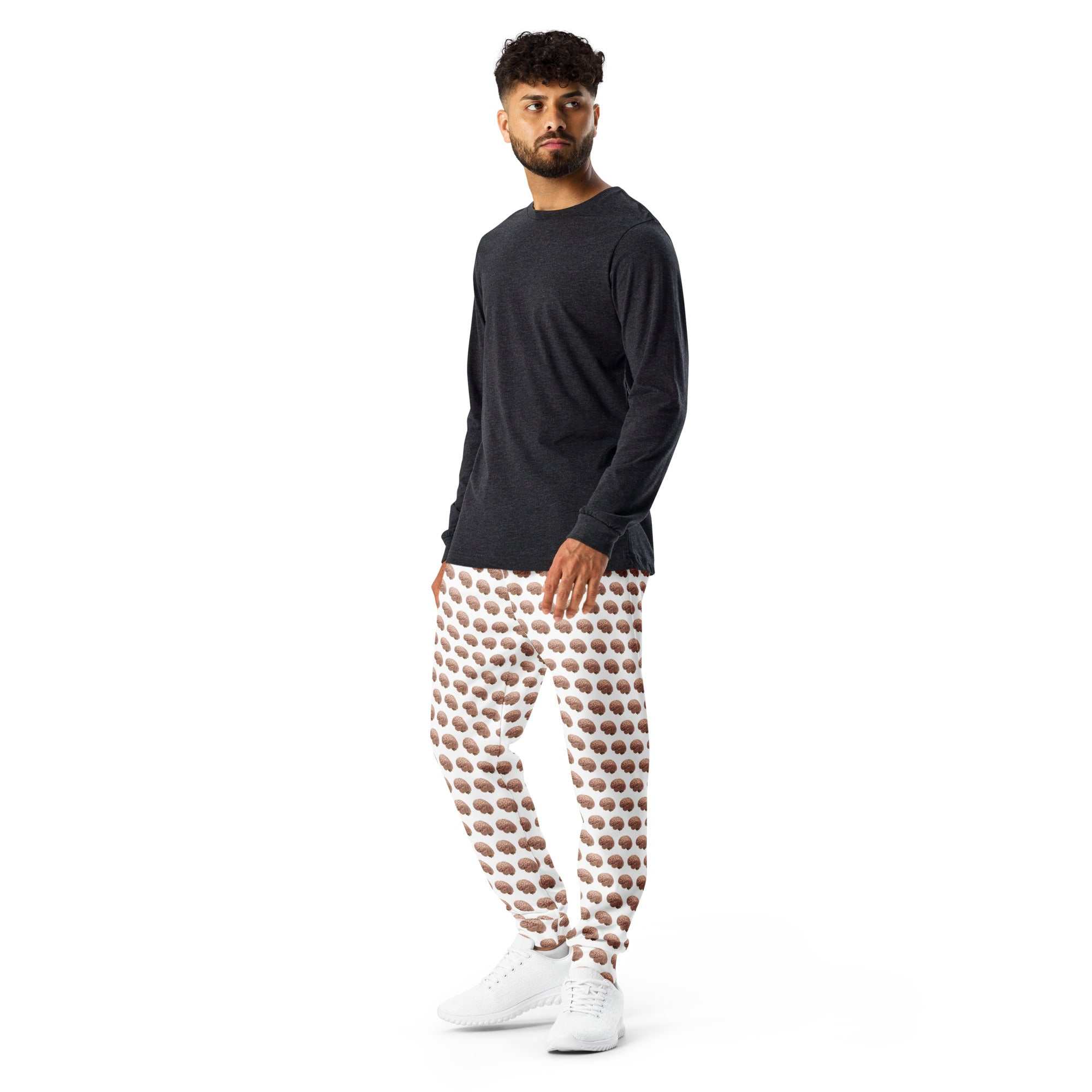 Man wearing white joggers with an all over brown brain print and a dark grey long sleeve shirt