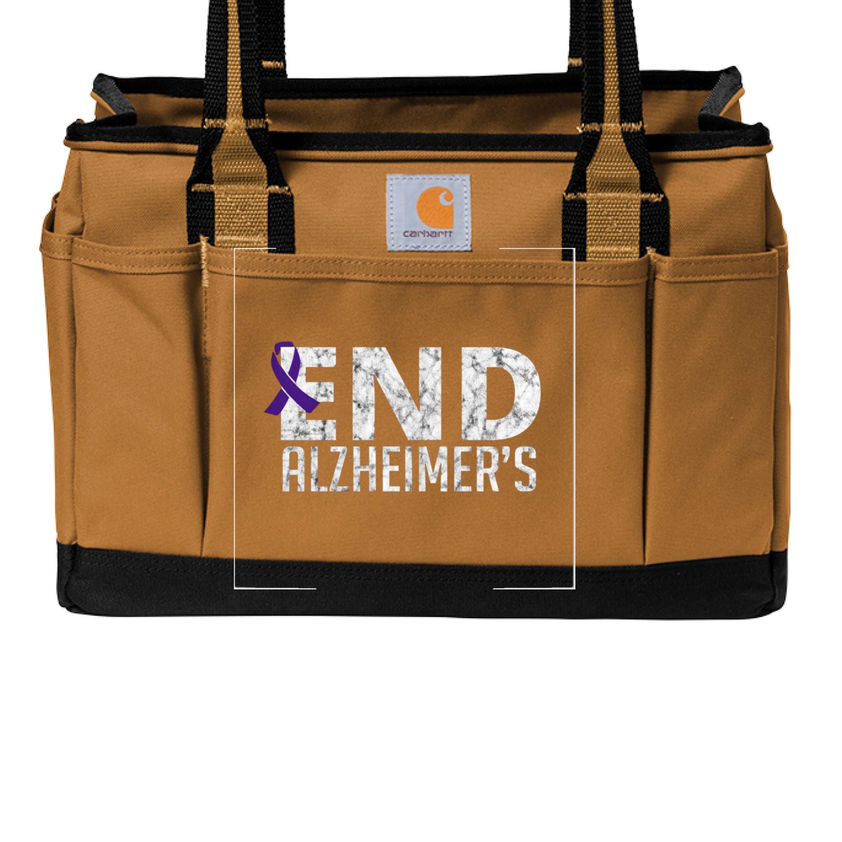Carhartt utility tote bag in brown with End Alzheimer's logo, durable fabric, and spacious design for carrying essentials.