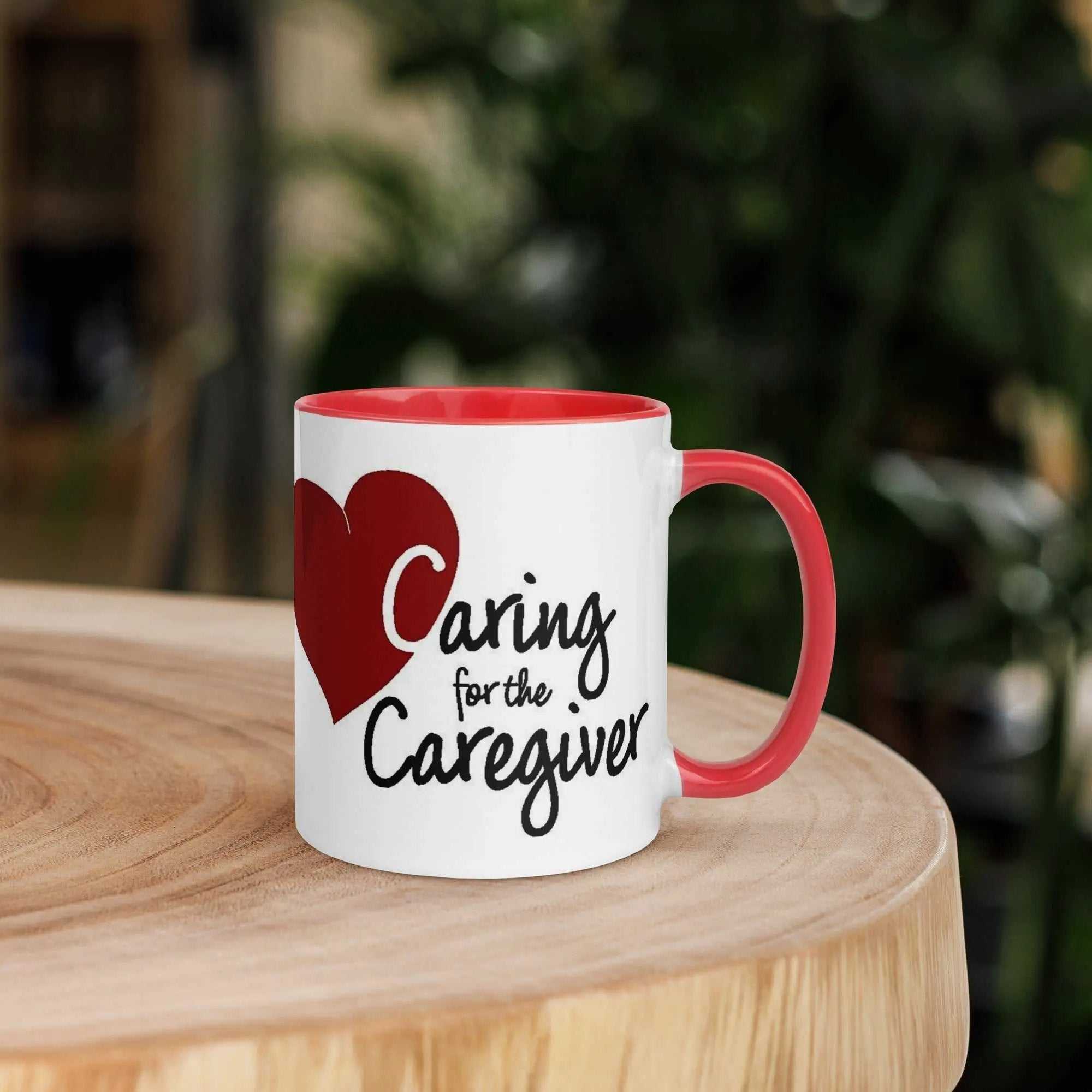 Caring for the Caregiver ceramic mug with red handle and rim and red heart graphic on wooden table