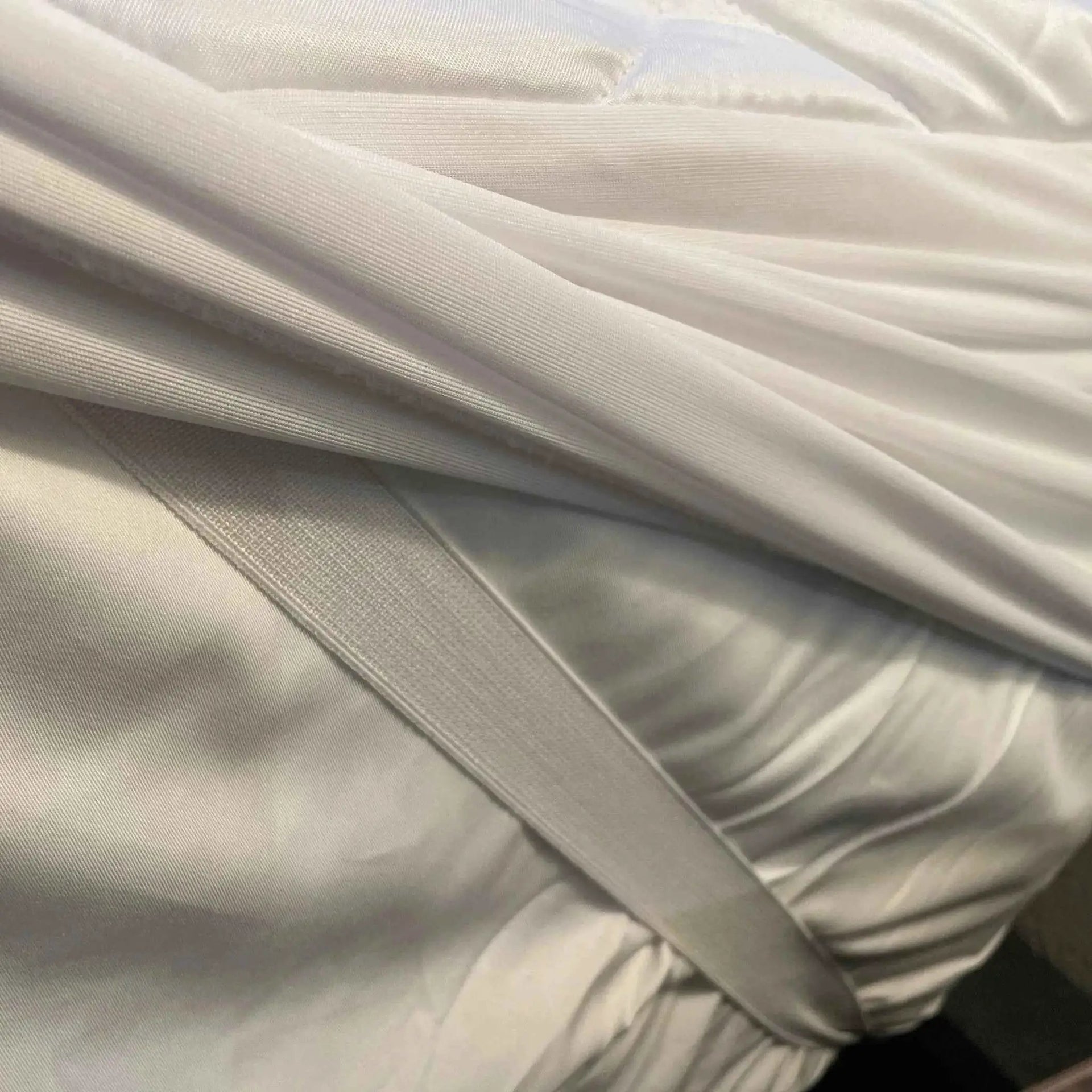 Rifz Textiles Inc GOTL Collection quilted waterproof mattress protector showing padded, water-resistant bedding accessory on a bed.