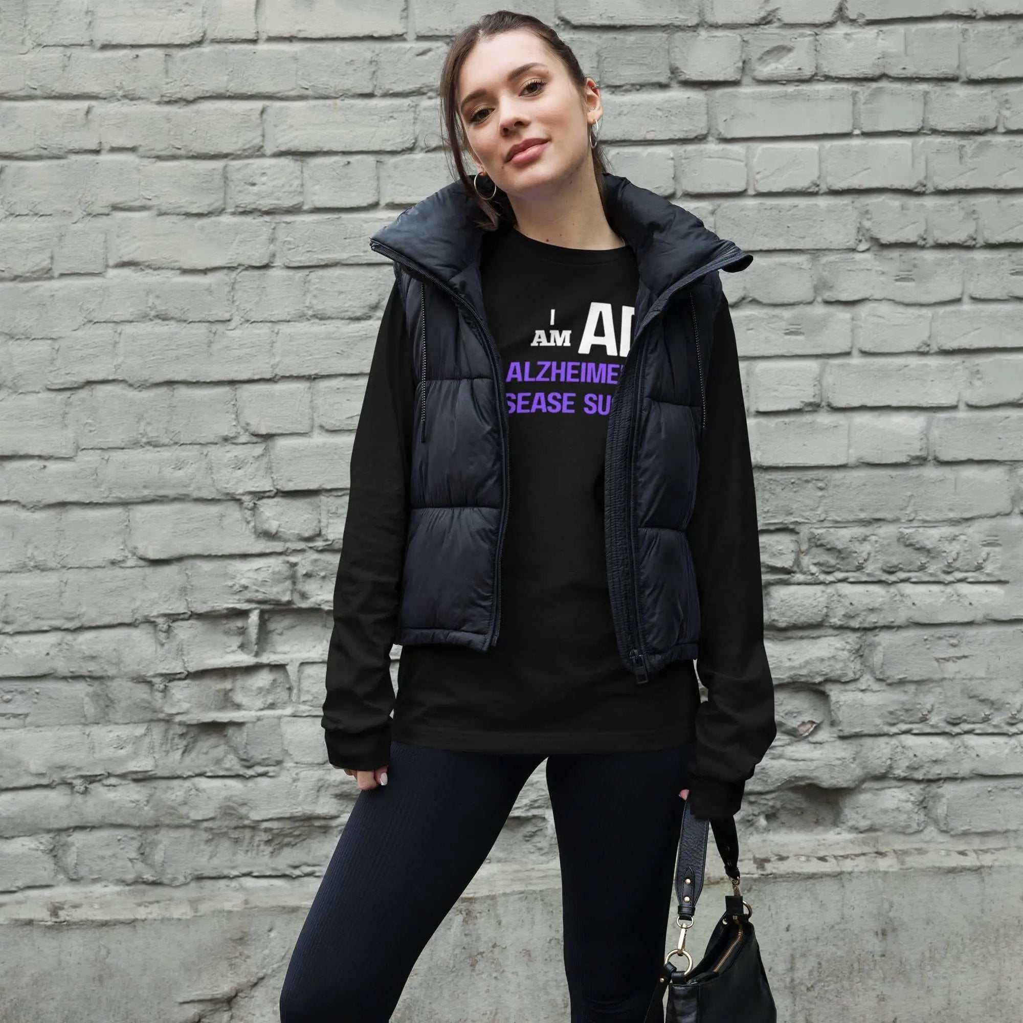 Person wearing I AM AD Long Sleeve Tee-Shirt Unisex for Alzheimer's Awareness under a black puffer vest