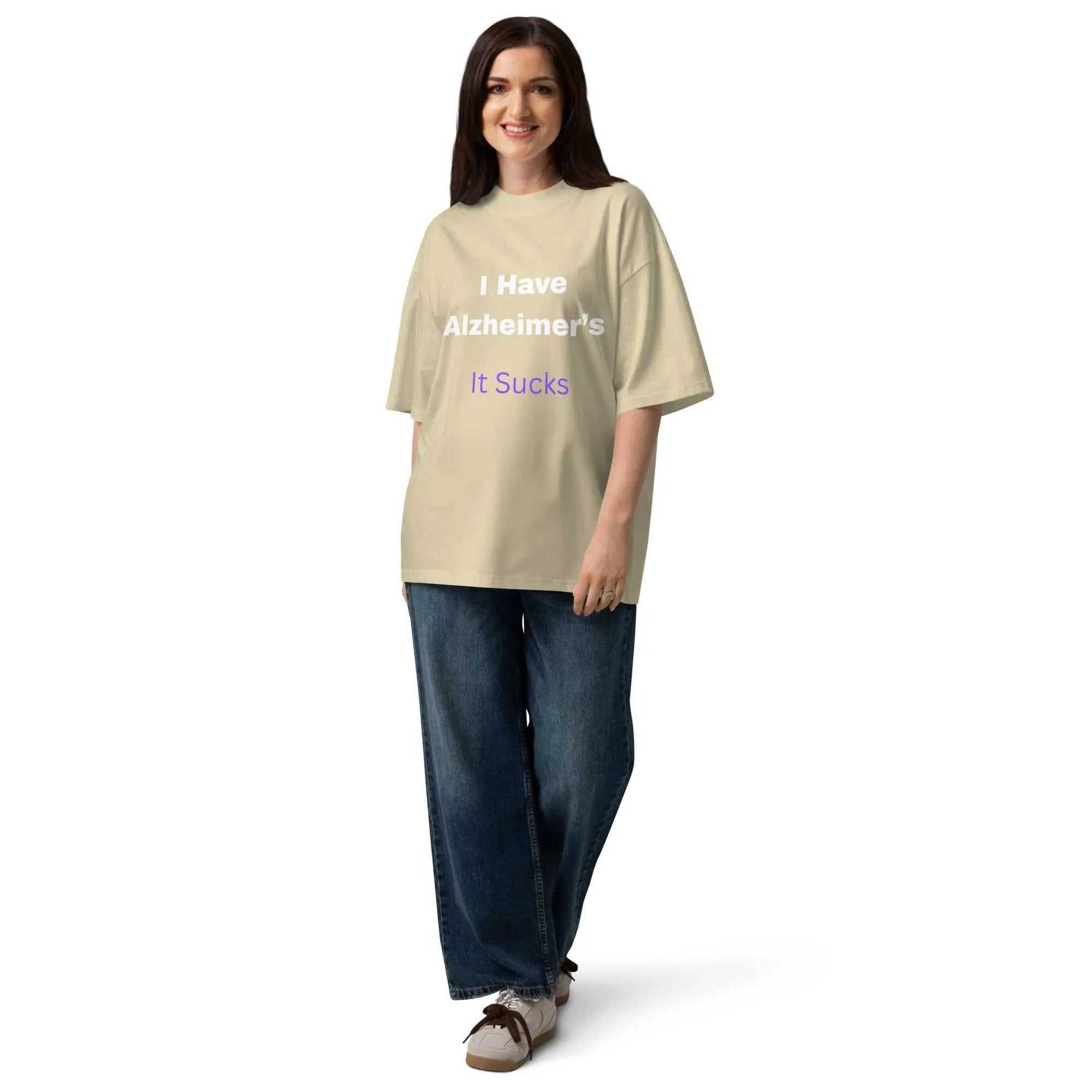 Woman wearing an oversized beige Alzheimer's Awareness T-Shirt with the text I Have Alzheimer's It Sucks