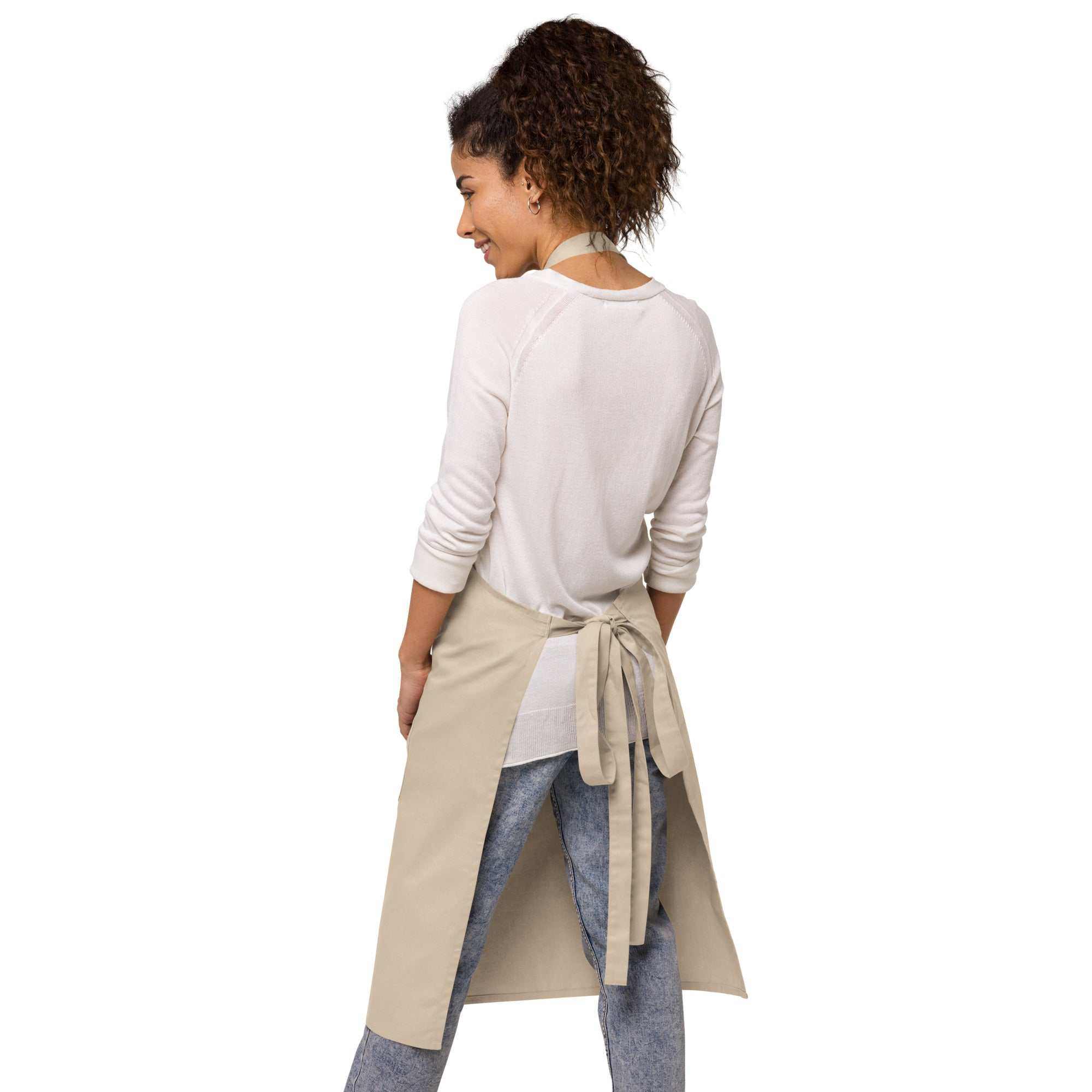 Woman wearing a beige Caregiver Apron tied at the back