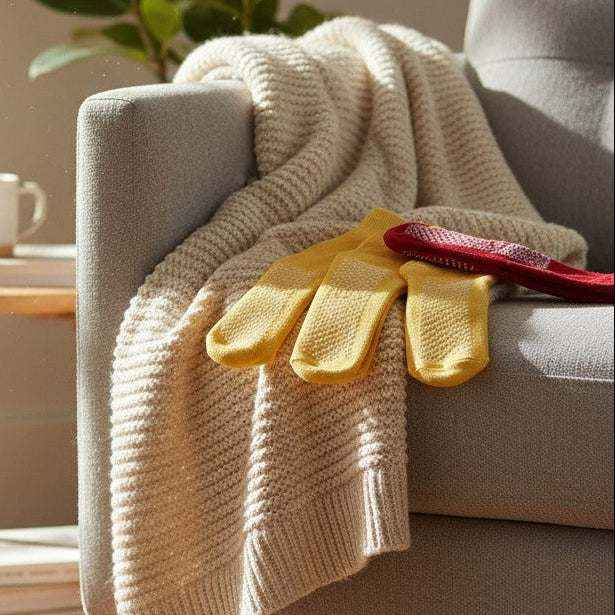 Yellow healthcare patient slipper socks by Rifz Textiles Inc, designed for comfort and stability, ideal for fall-risk care settings.