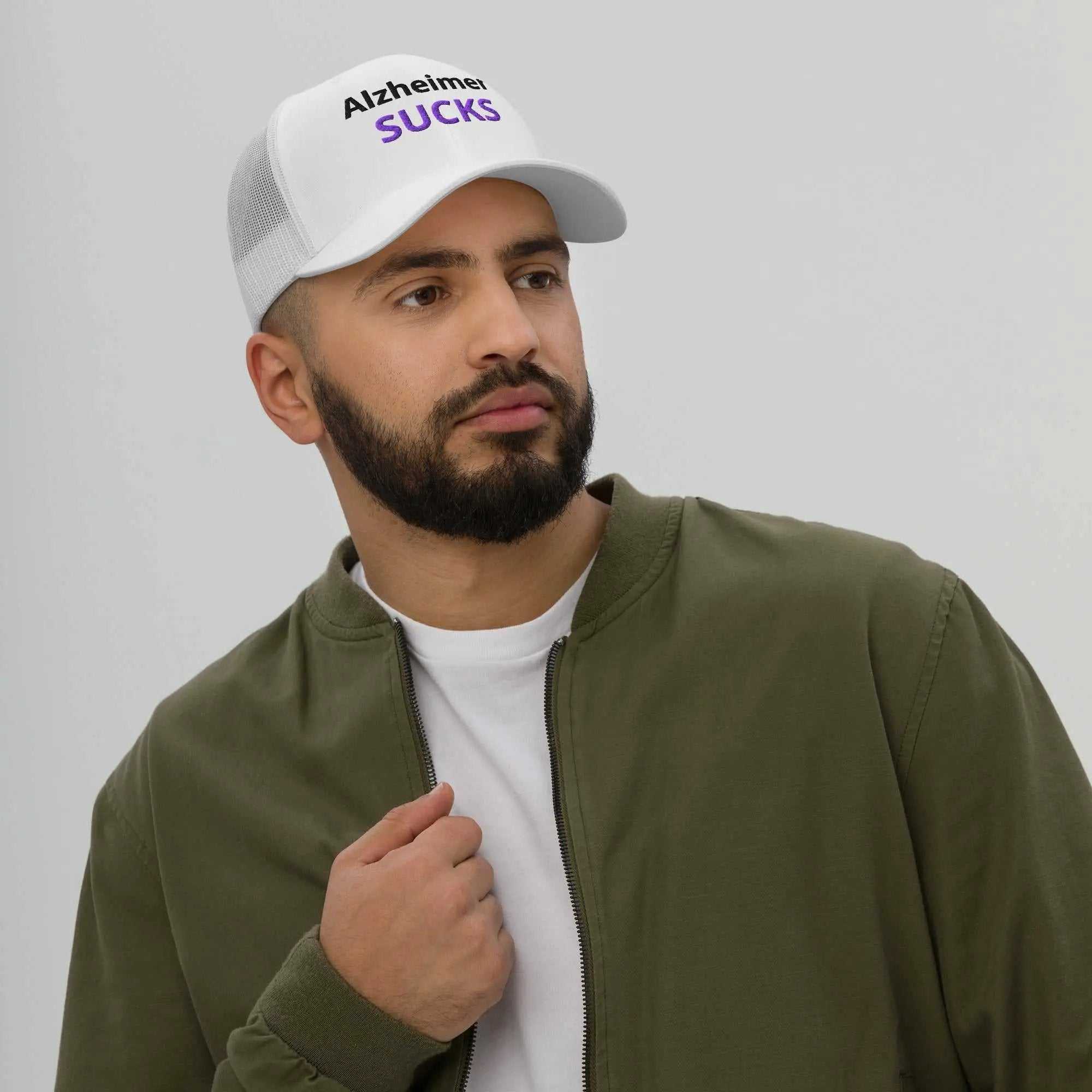 Man wearing a white Alzheimer's embroidered trucker cap with black and purple text
