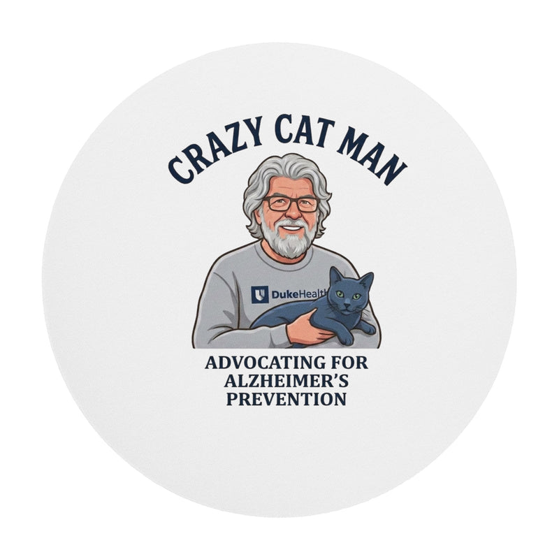 The Cat Man signature round mouse pad featuring an illustration of a man holding a cat