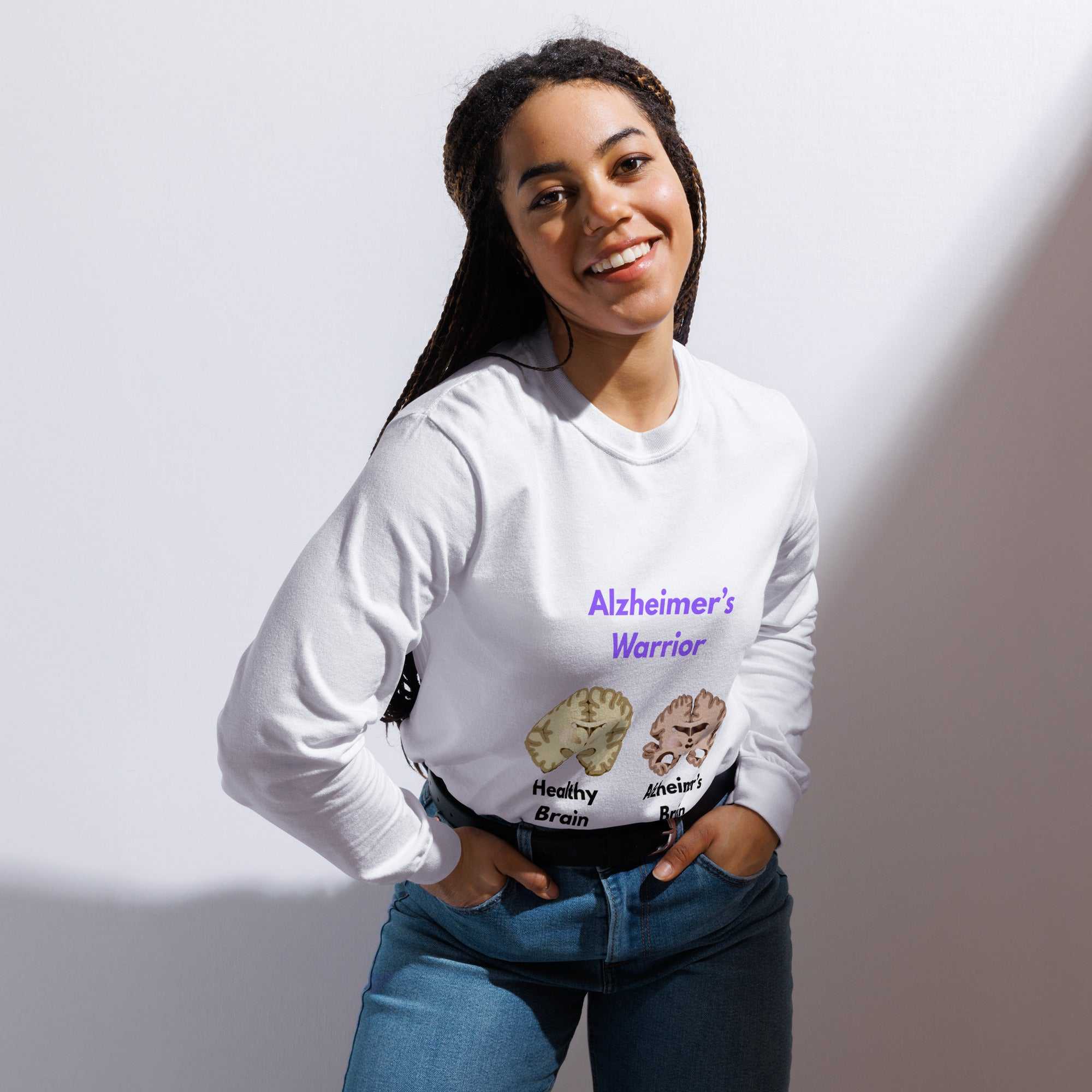 Person wearing white Alzheimer's Warrior long-sleeve shirt with healthy and Alzheimer's brain illustrations