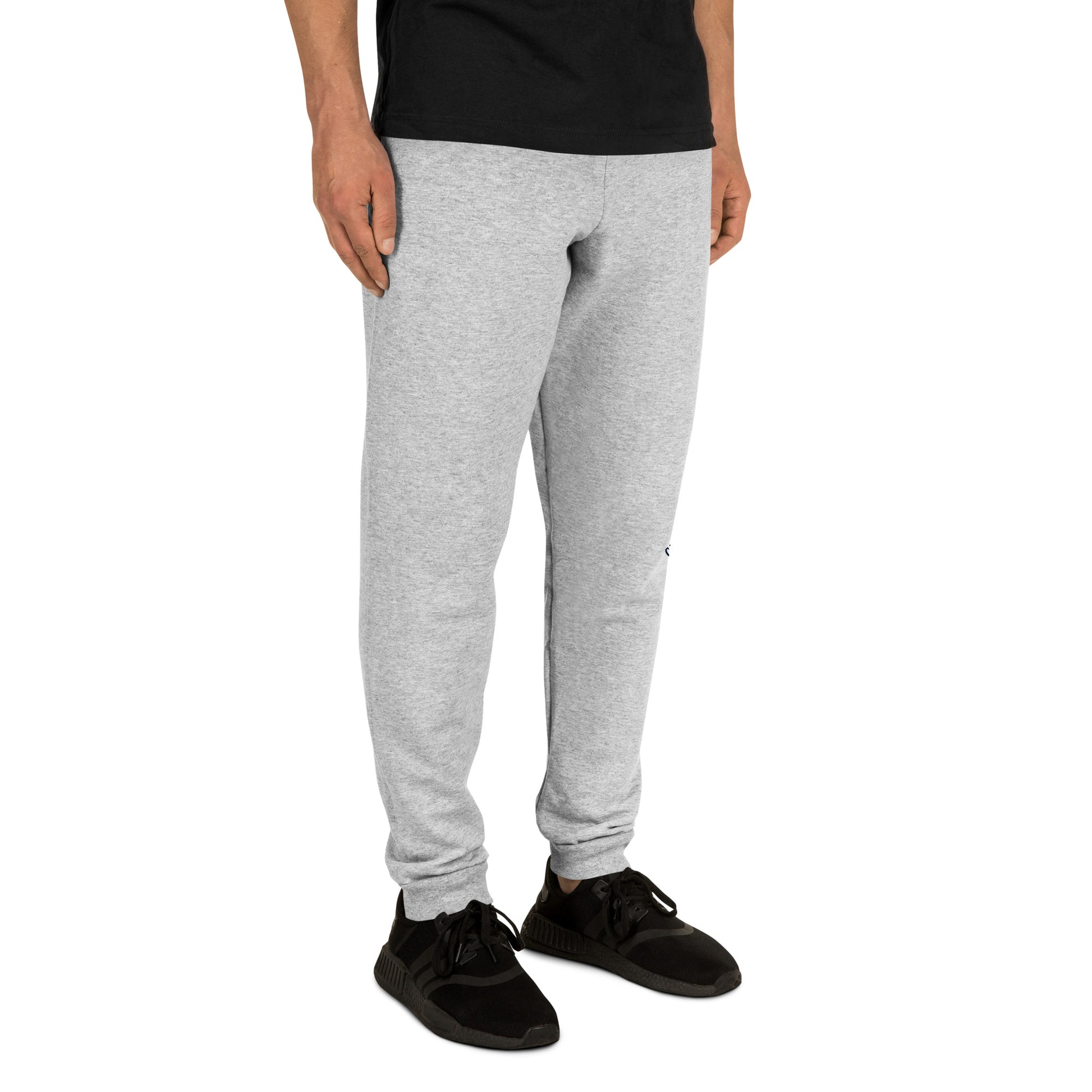 Person wearing grey unisex joggers for Alzheimer's prevention with Cat Man Signature logo and black sneakers