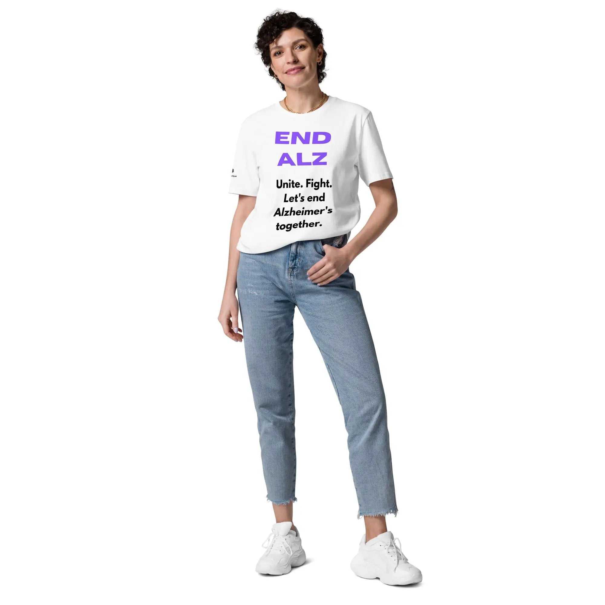 Person wearing white END ALZ unisex t-shirt with purple and black text and blue jeans