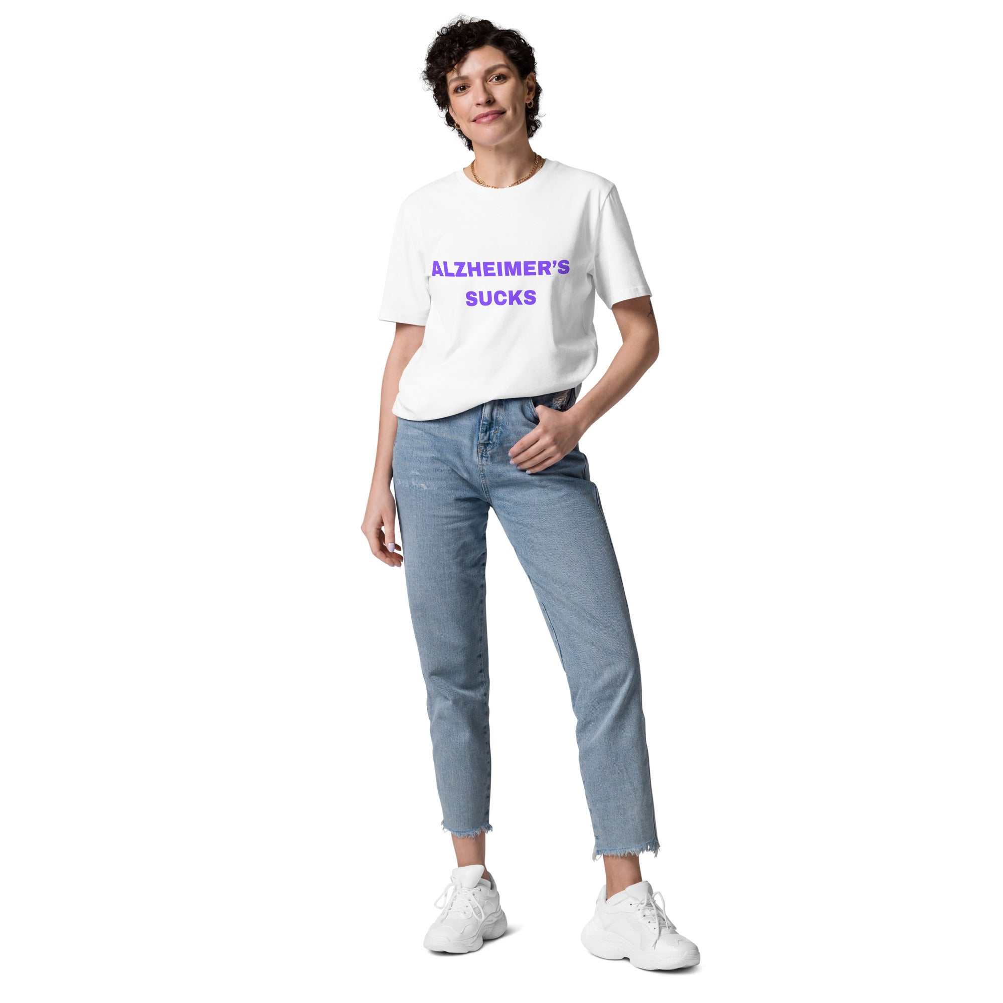 Person wearing a white Alzheimers Sucks unisex organic cotton t-shirt with blue jeans and white sneakers