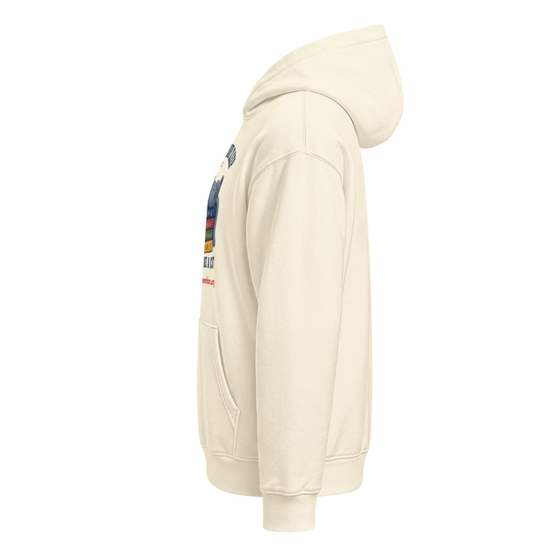 Side view of a cream unisex relaxed mid-weight hooded sweatshirt with a graphic print on the chest