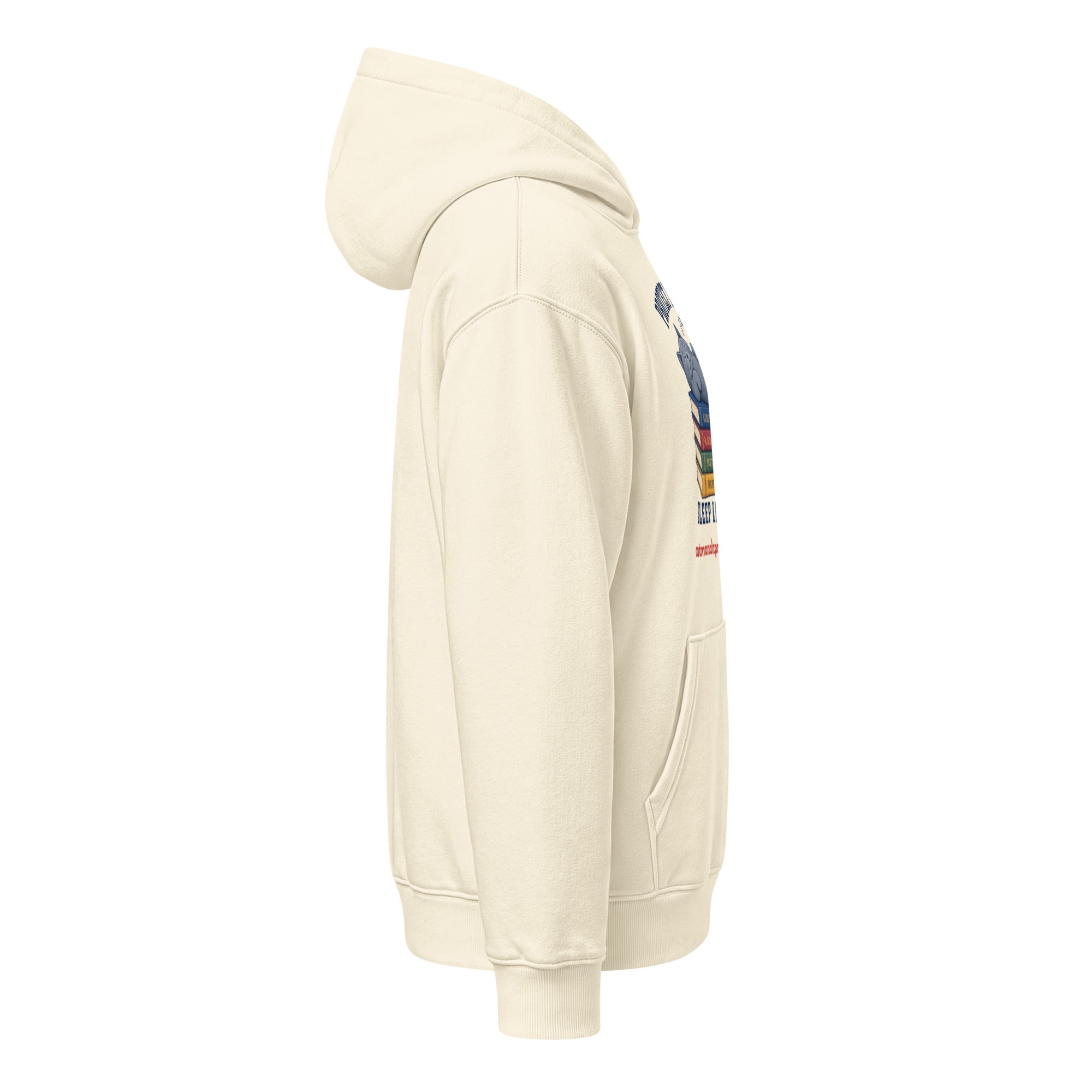 Side view of a cream unisex relaxed mid-weight hooded sweatshirt with a graphic of a stack of books