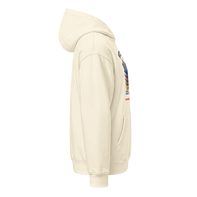 Side view of a cream unisex relaxed mid-weight hooded sweatshirt with a graphic of a stack of books