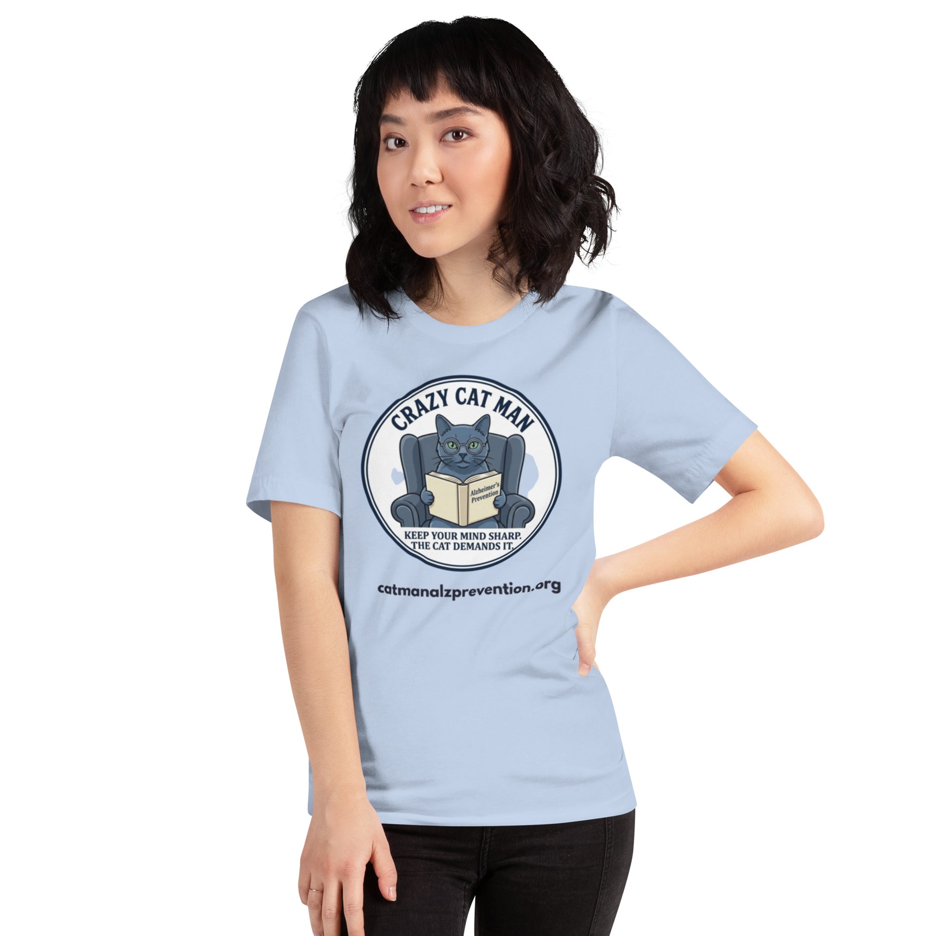 Woman wearing a light blue Crazy Cat Man Reading t-shirt featuring a cat in a chair reading a book