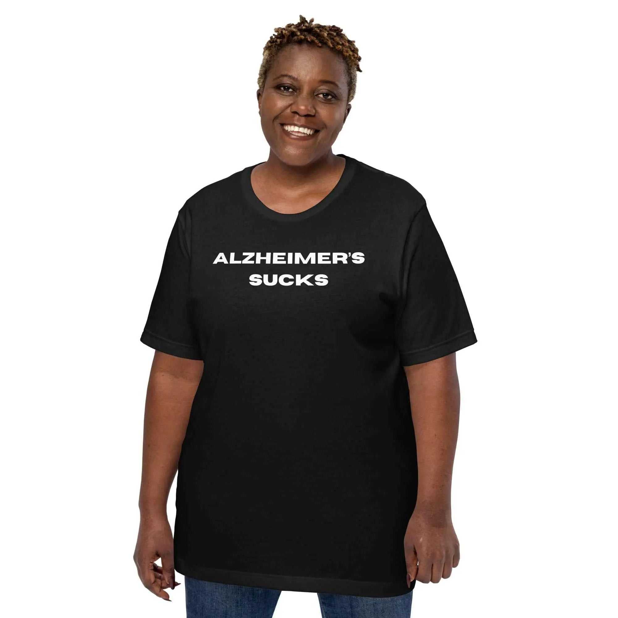 Person wearing a black Alzheimer's Sucks unisex t-shirt with white text
