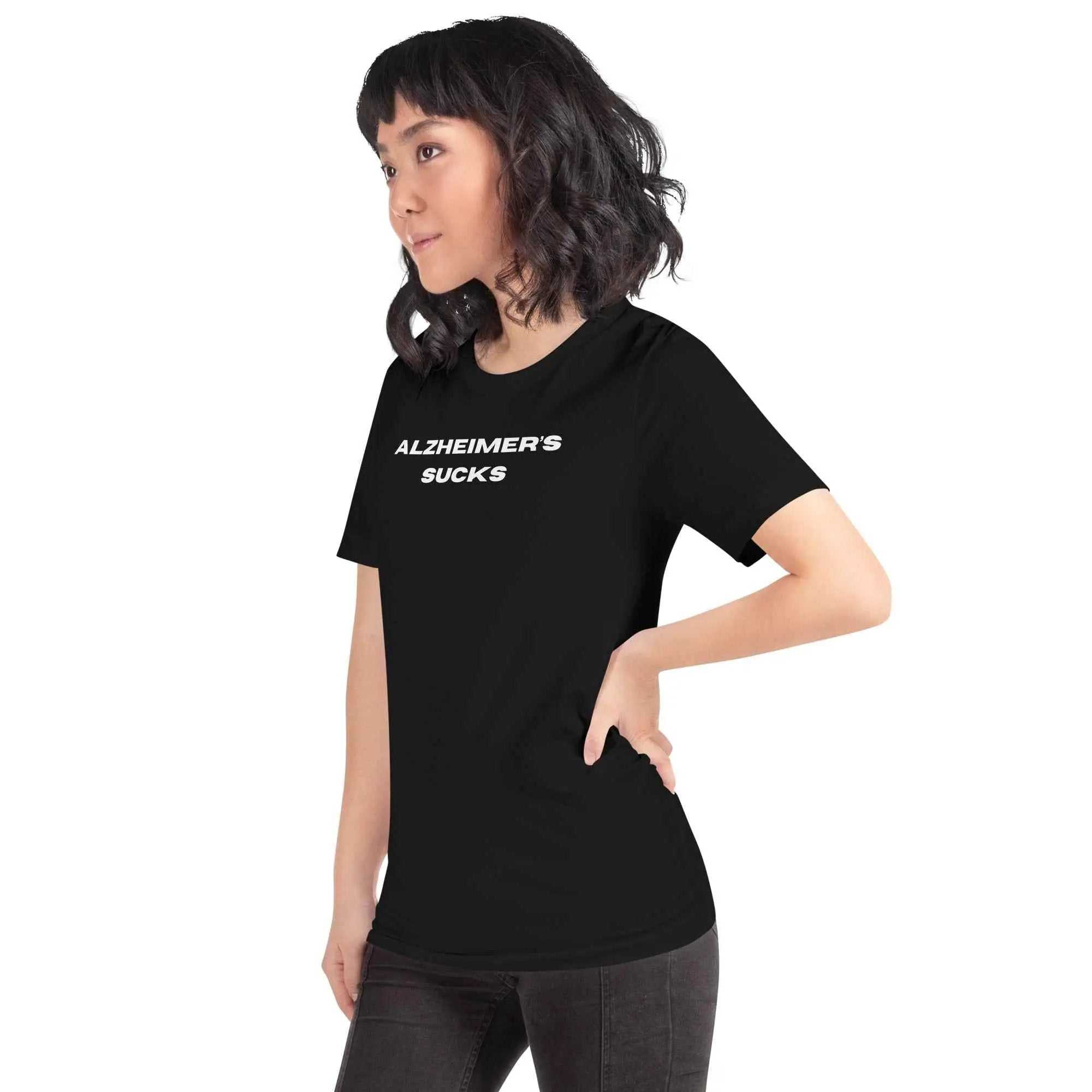 Person wearing black Alzheimer's Sucks unisex t-shirt with white text
