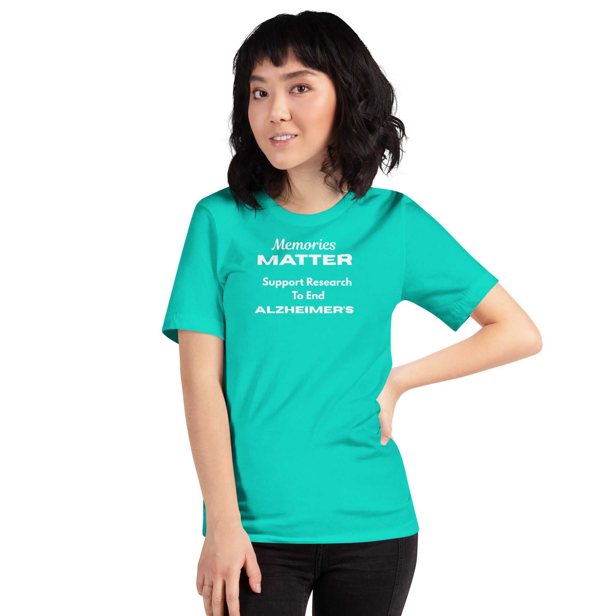 Person wearing a teal Memories Matter Alzheimer's Awareness T-shirt with white text