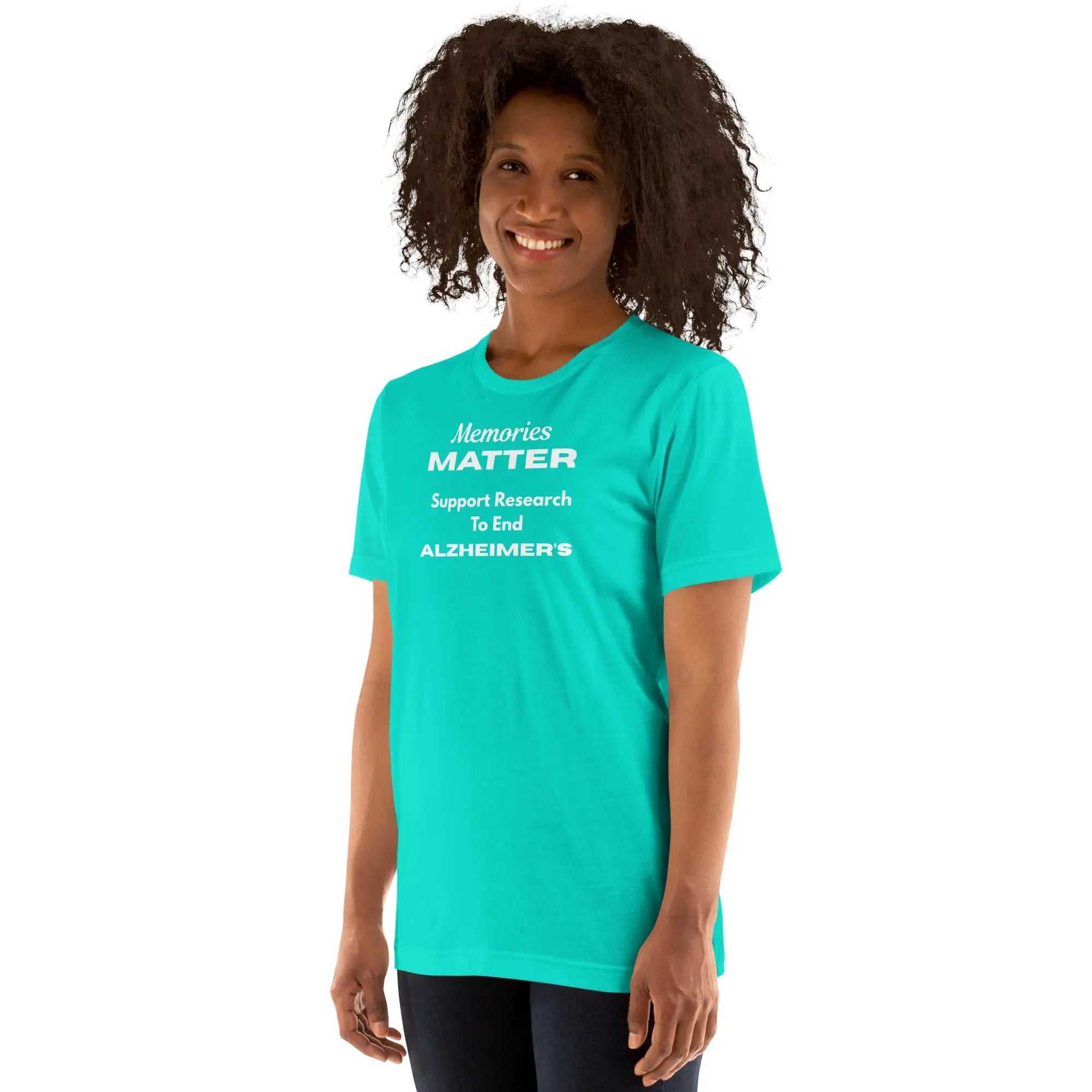 Person wearing a teal Memories Matter Alzheimer's Awareness T-Shirt with white text
