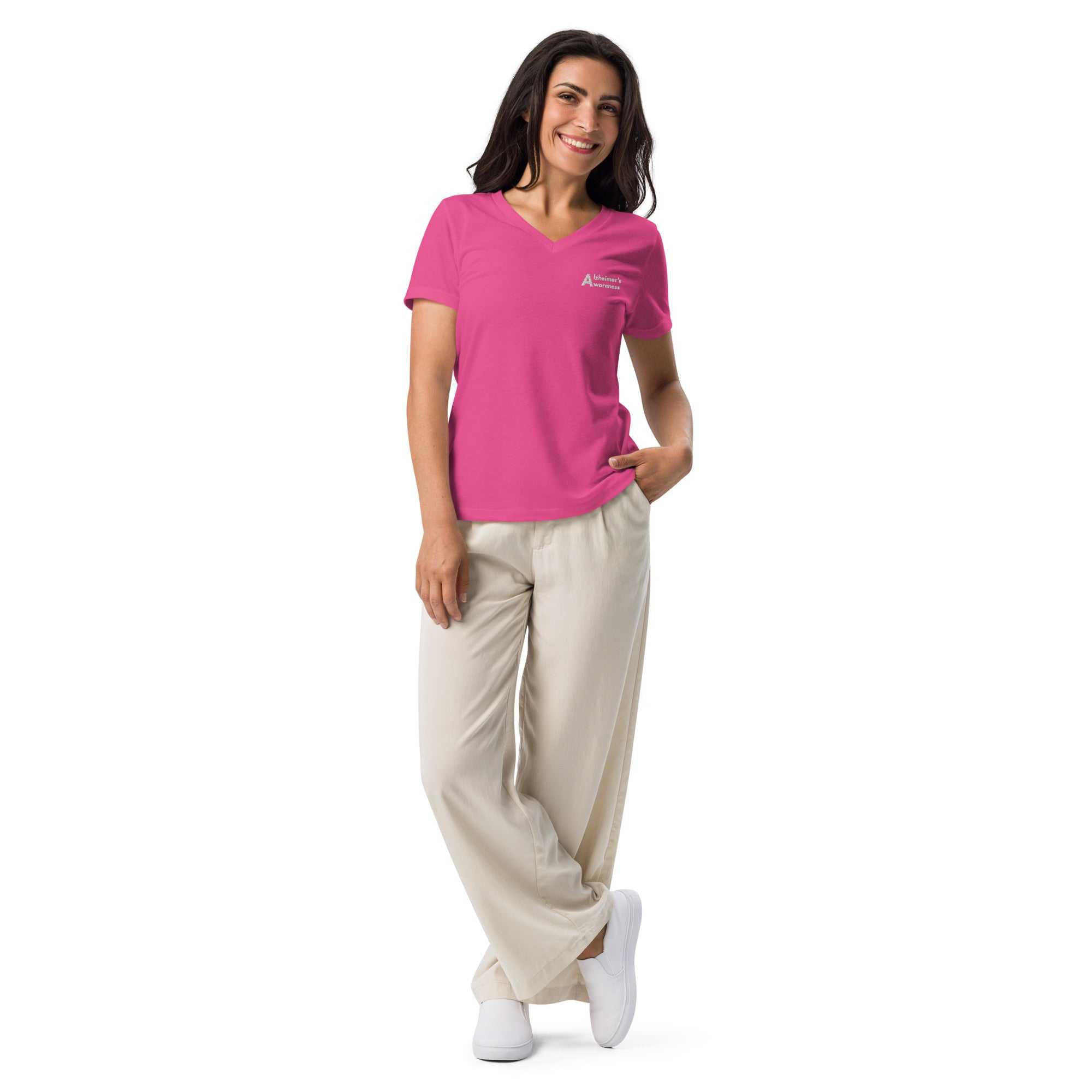 Woman wearing a pink Alzheimer's Awareness premium ultra-soft heather women's v-neck tee with beige trousers